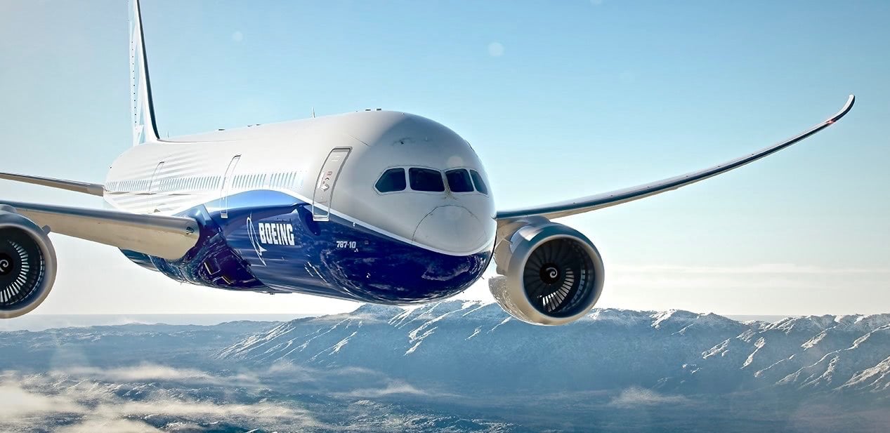 front view of the 787 boeing flying with blue sky