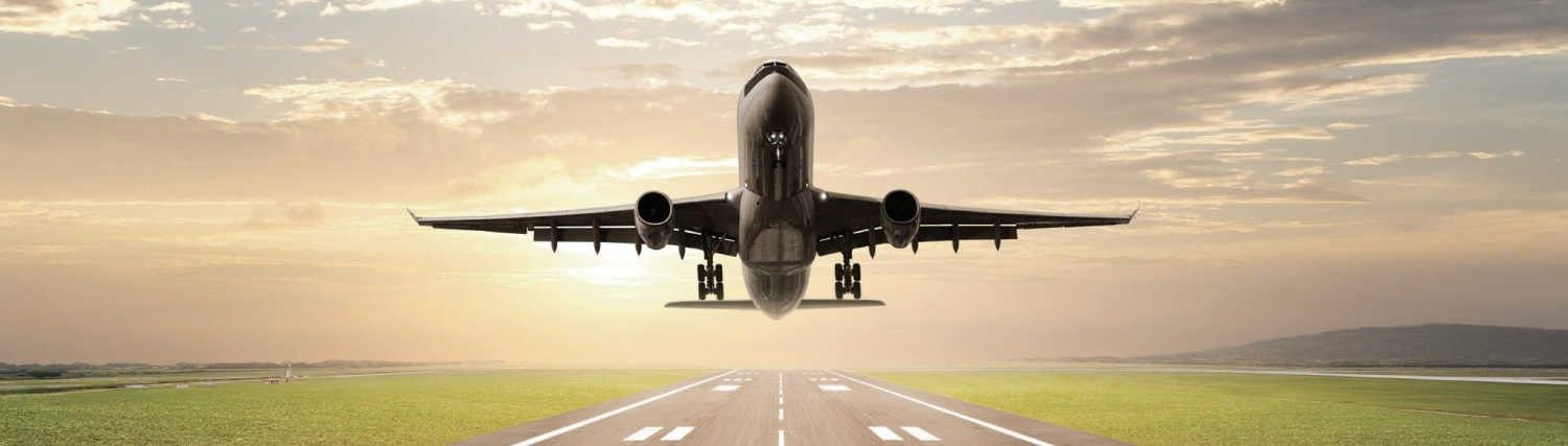 front view of passenger plane taking off with sunrise background