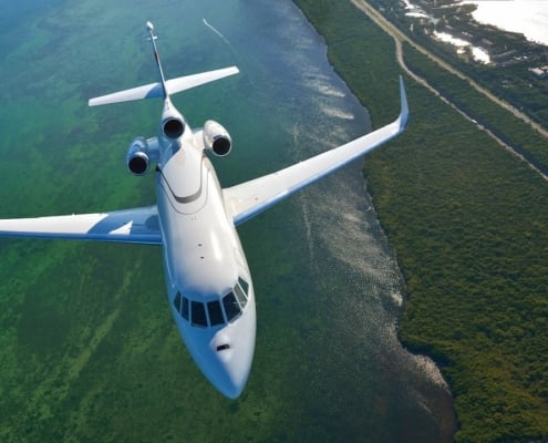 A trijet flying through countryside