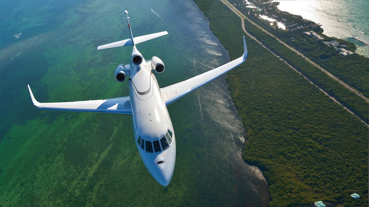 A trijet flying through countryside