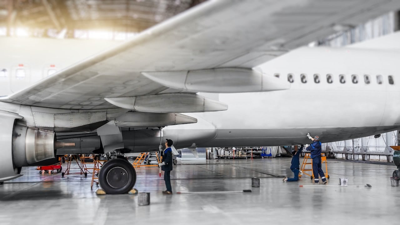 Mechanics preparing an aircraft for flight