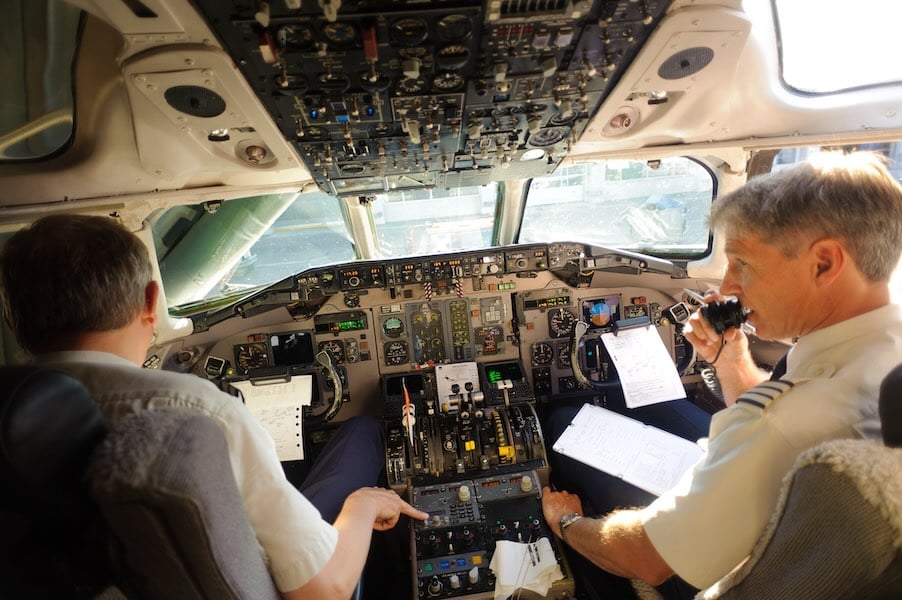 Two pilots reviewing the preflight checklist