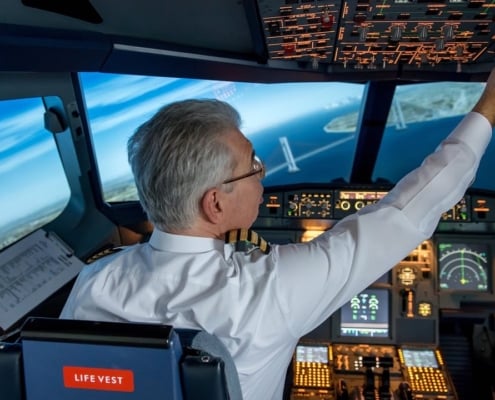 A pilot controlling the instruments that are in the cockpit