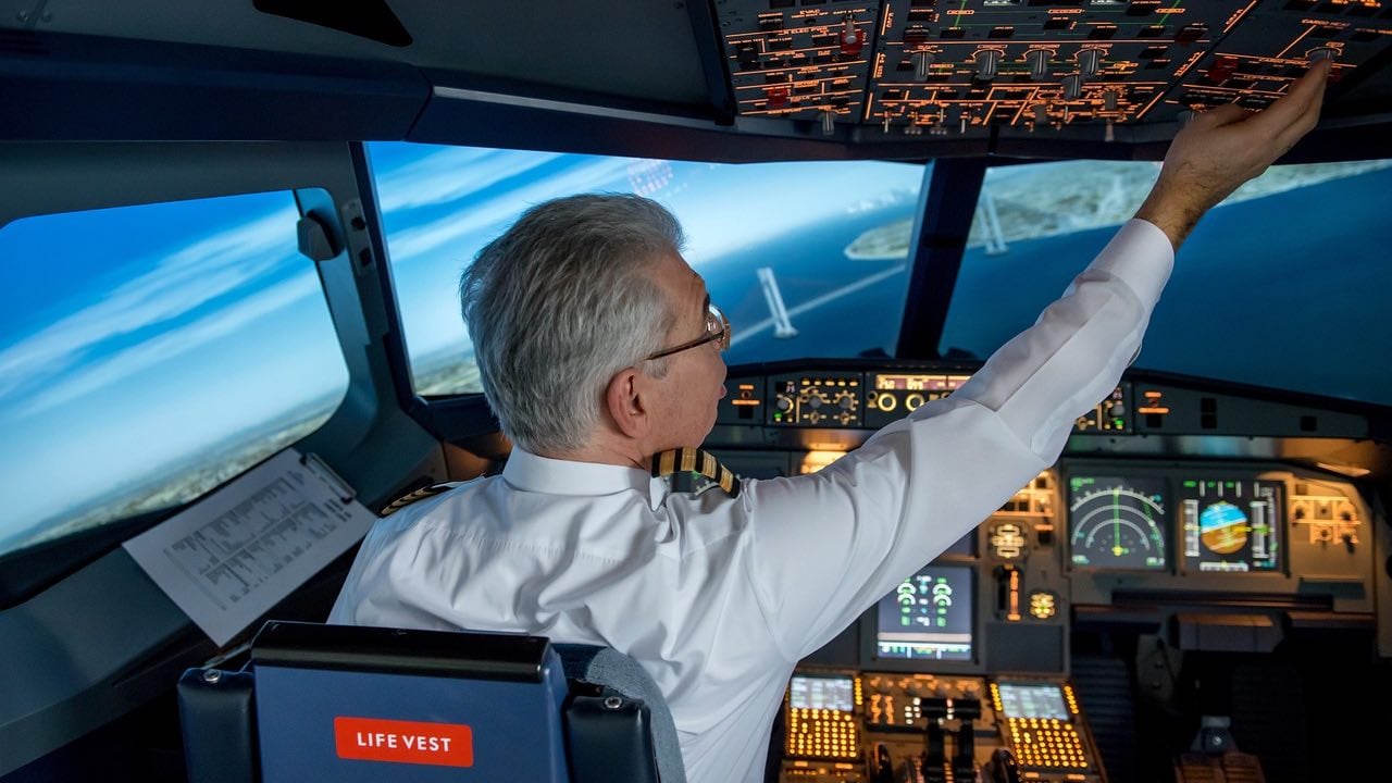 A pilot controlling the instruments that are in the cockpit