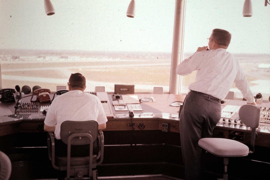 Two air traffic controllers working in a control tower